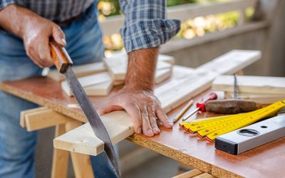 Craftsman at work on wooden boards.